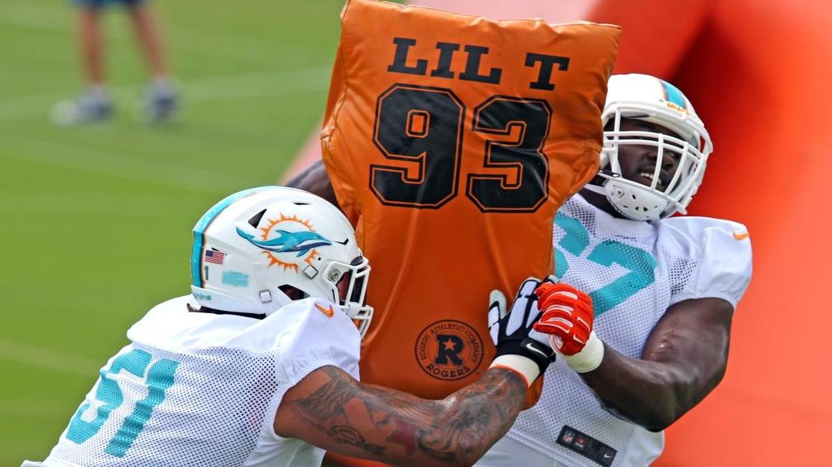 Miami Dolphins Mike Pouncey 51, hits first round draft pick Laremy Tunsil 67, during day 5 of the OTAs at the Miami Dolphins training facility in Davie, Florida, June 1, 2016.