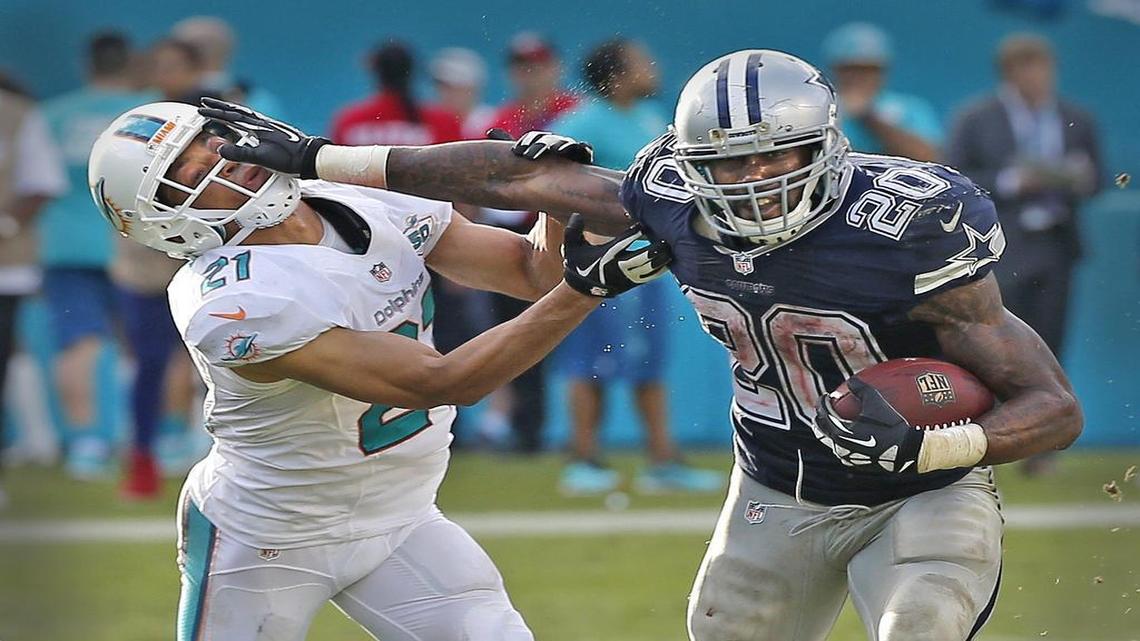 Miami Dolphins’ Brent Grimes gets stiff-armed by Dallas Cowboys’ Darren McFadden in the fourth quarter at Sun Life Stadium in Miami Gardens, Florida, November 22, 2015.