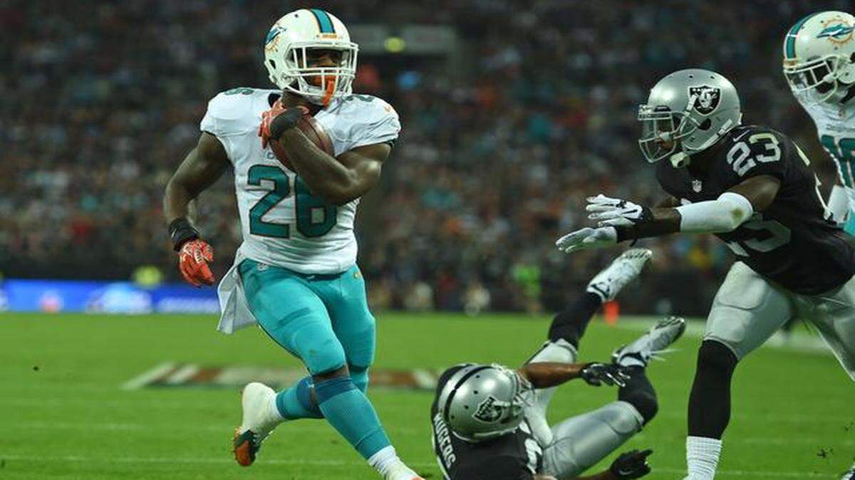 <cutline_leadin>Getting the job done:</cutline_leadin> Dolphins running back Lamar Miller races into the end zone for a touchdown during last week’s convincing victory over the Oakland Raiders at Wembley Stadium in London.