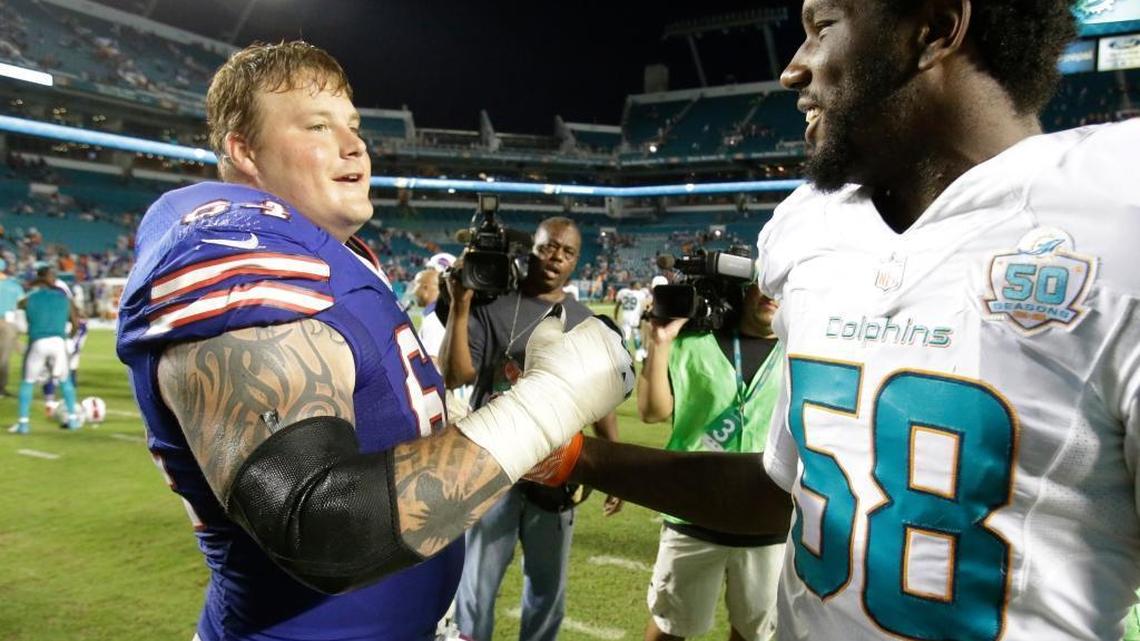 Miami Dolphins linebacker/defensive end Chris McCain (58) greets Buffalo Bills offensive guard Richie Incognito after the Bills’ 41-14 victory against Miami at Sun Life Stadium on Sunday, Sept. 27, 2015.