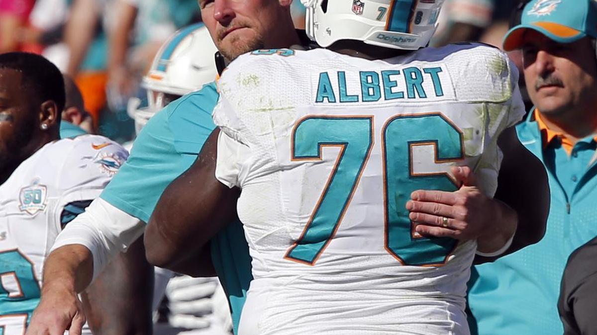 
Miami Dolphins left tackle Branden Albert hugs interim head coach Dan Campbell near the end of the fourth quarter against the Tennessee Titans at Nissan Stadium in Nashville, Tenn., on Sunday, October 18, 2015.
