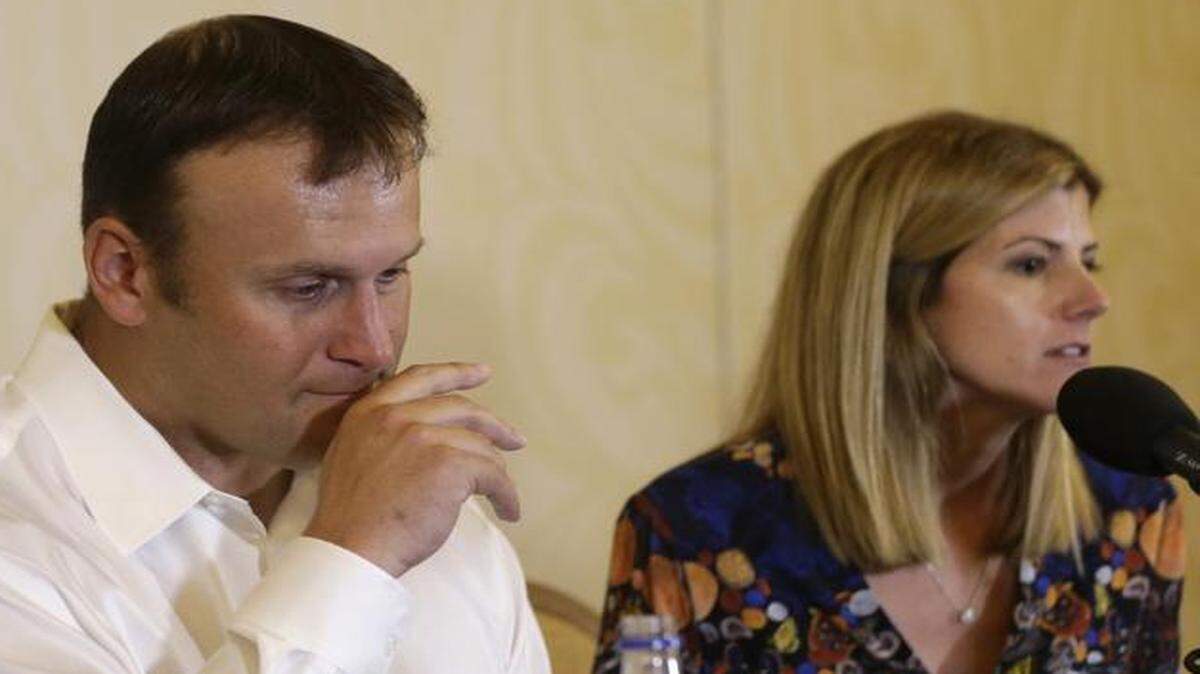 
Former Miami Dolphins fullback Rob Konrad listens while wife Tammy responds to a question during a news conference Monday, Jan. 12, 2015, in Plantation, Fla. 
