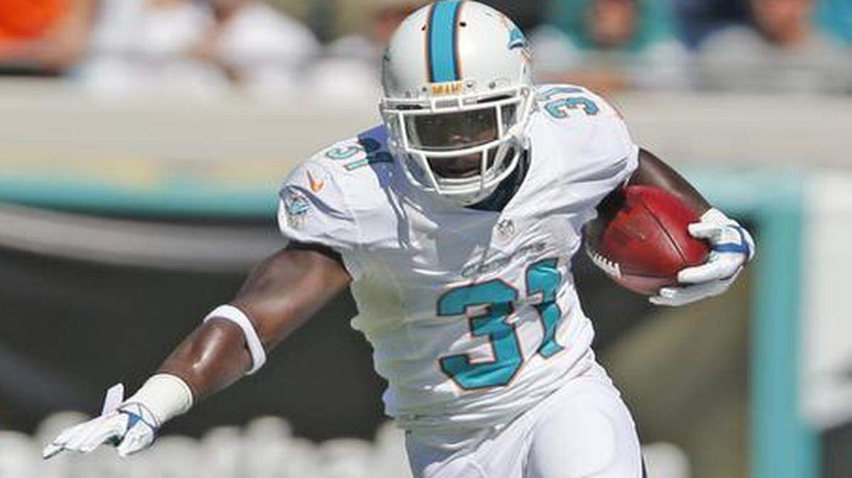 
Miami Dolphins free safety Michael Thomas (31) advances the ball after recovering a blocked kick in the first quarter against the Jacksonville Jaguars at Everbank Field in Jacksonville on Sunday, Oct. 26, 2014.
