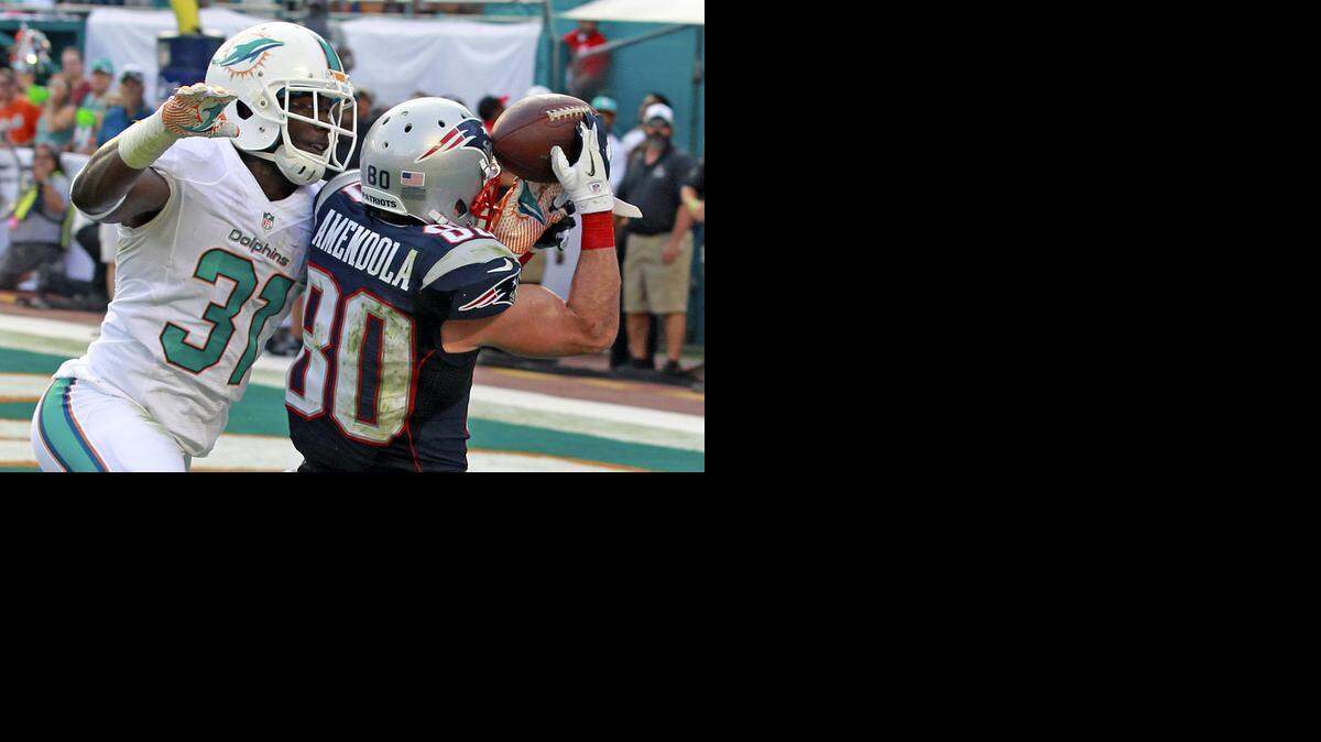 
Miami Dolphins’ Michael Thomas breaks up a pass intended for the New England Patriots’ Danny Amendola as the Dolphins won at Sun Life Stadium in Miami Gardens on Dec. 15, 2013.
