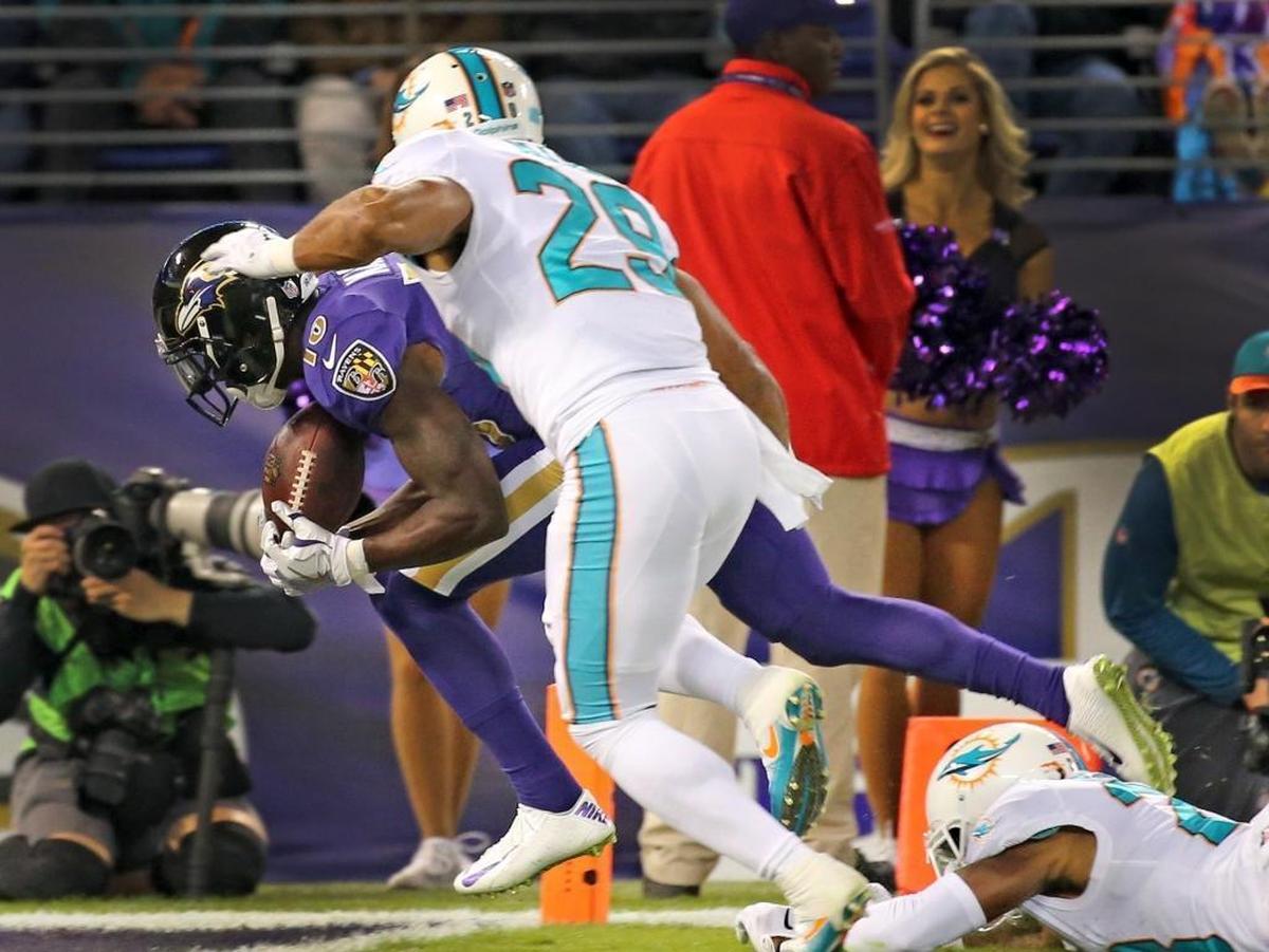 Miami Dolphins Nate Allen (29) and Bobby McCain (28) fail to stop Baltimore Ravens Jeremy Maclin (18) as he catches a touchdown pass in the first quarter at the M&T Bank Stadium in Baltimore, Maryland, Oct. 26, 2017.