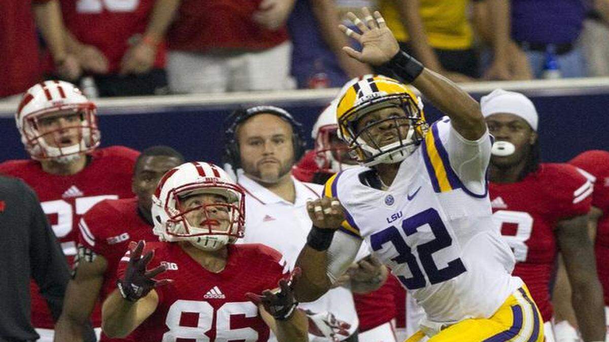 
LSU cornerback Jalen Collins (32) breaks up a pass intended for Wisconsin wide receiver Alex Erickson Saturday, Aug. 30, 2014, in Houston.
