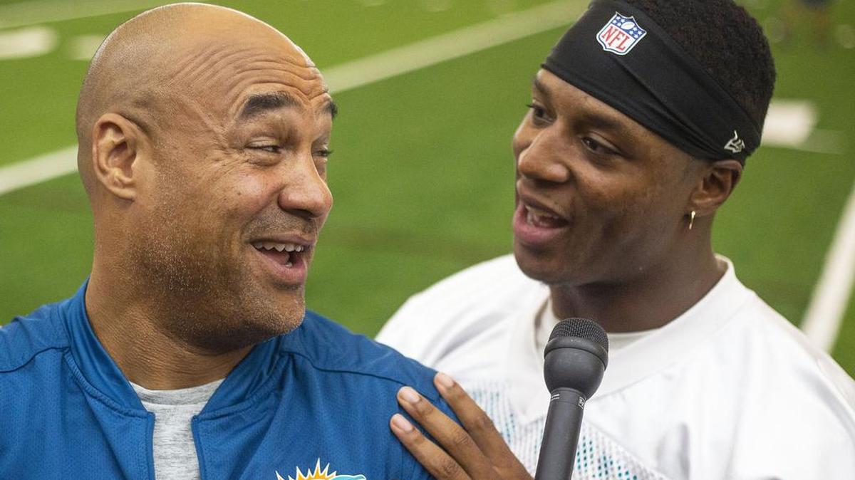 Dolphins running back coach Eric Studesville and Dolphins running back Kenyan Drake joke around after OTA practice.