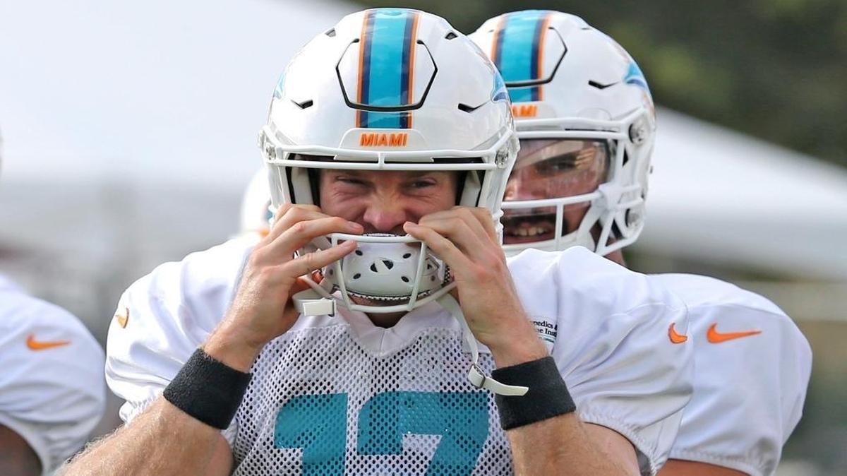 Quarterback Ryan Tannehill puts on his helmet as he prepares to start practice on Tuesday.