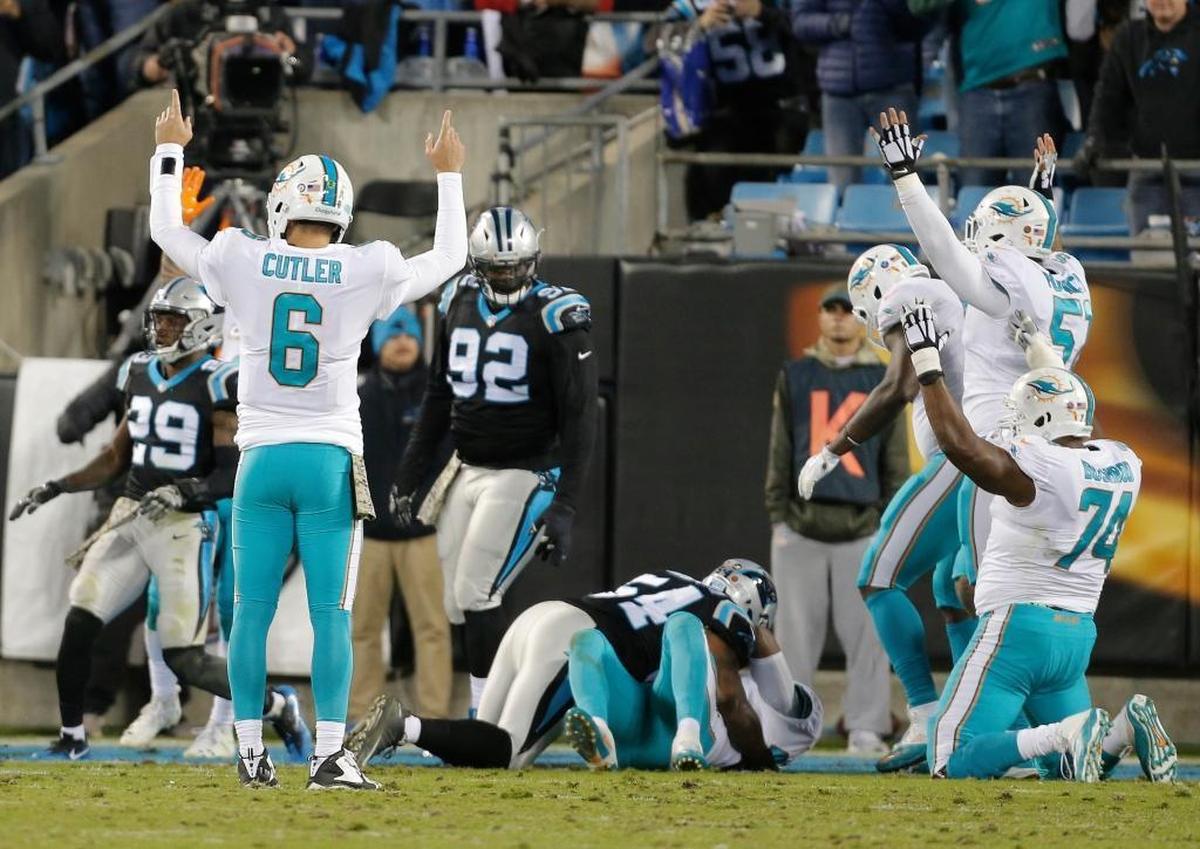 Miami Dolphins' Jay Cutler (6) reacts after touchdown against the Carolina Panthers in the first half of an NFL football game in Charlotte, N.C., Mon., Nov. 13, 2017.