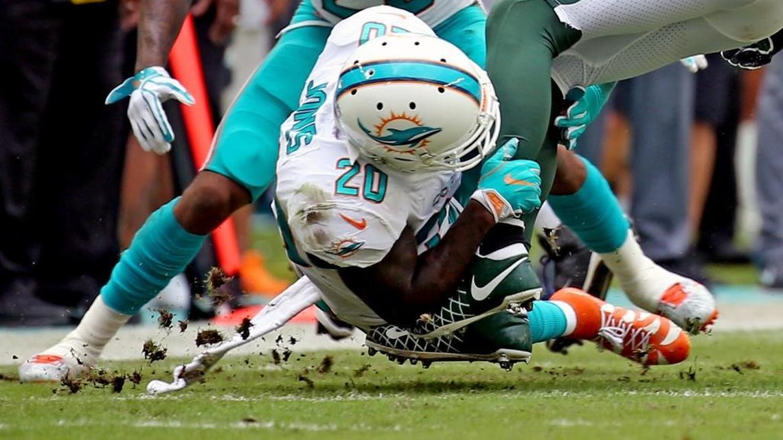 Miami Dolphins Reshad Jones (20) tackles a New York Jets player Sunday, Oct. 22, 2017, at Hard Rock Stadium in Miami Gardens, Fla.
