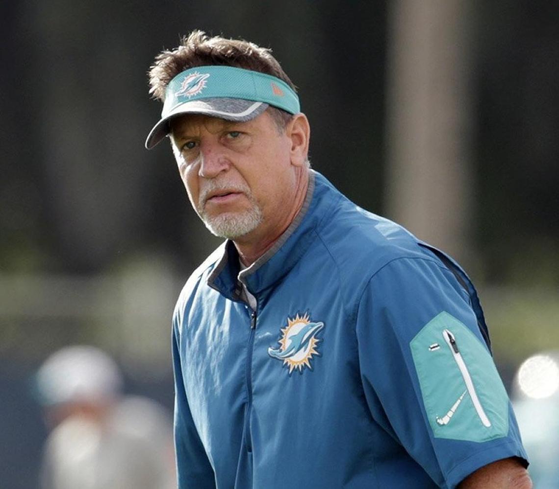 FILE - In this Aug. 16, 2016, file photo, Miami Dolphins offensive line coach Chris Foerster watches as players do drills during practice at NFL football training camp in Davie, Fla. The NFL and the Miami Dolphins say they're aware of a social media video allegedly showing offensive line coach Chris Foerster snorting a white powdery substance. NFL spokesman Brian McCarthy said Monday, Oct. 9, 2017, the league will review the 56-second video, which was posted on Facebook and Twitter. (AP Photo/Lynne Sladky, File)