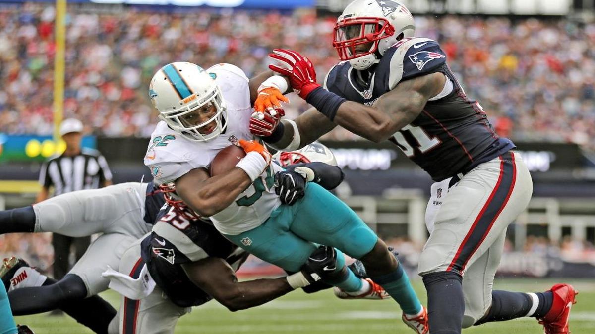 Miami Dolphins running back Kenyan Drake (32) dives over the goal line in the fourth quarter as the New England Patriots host the Miami Dolphins at Gillette Stadium on Sun., Sept. 18, 2016.