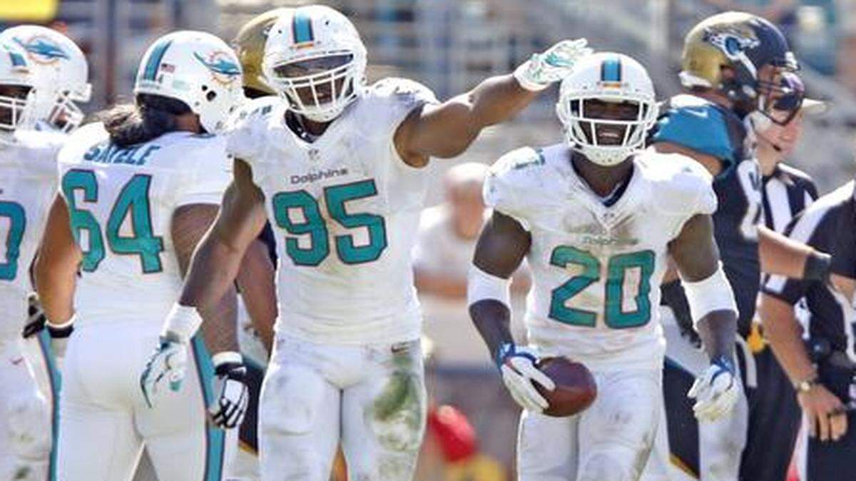 
Miami Dolphins strong safety Reshad Jones (20) holds onto the ball after Miami recovers a fumble in the second quarter against the Jacksonville Jaguars at Everbank Field in Jacksonville on Sunday, Oct. 26, 2014.
