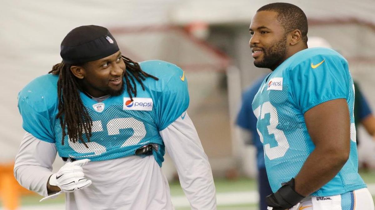 
Miami Dolphins middle linebacker Kelvin Sheppard (52) and outside linebacker Jelani Jenkins (53) chat during practice, Tuesday, Aug. 11, 2015 in Davie, Fla. 
