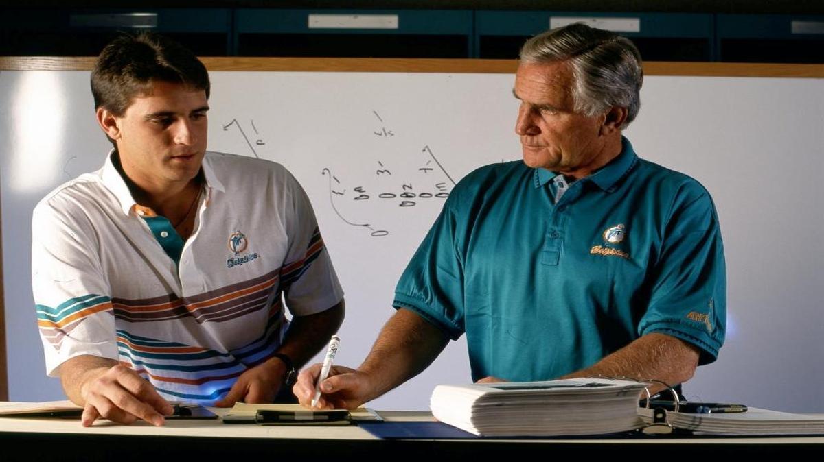 Miami Dolphins Hall of Fame head coach Don Shula diagrams a play for his son, assistant coach Mike Shula, in Miami, 1992.