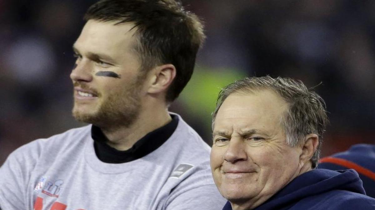 New England Patriots head coach Bill Belichick, right, and quarterback Tom Brady smile with the AFC trophy after the AFC championship NFL football game, Sunday, Jan. 22, 2017, in Foxborough, Mass. The New England Patriots defeated the the Pittsburgh Steelers 36-17 to advance to the Super Bowl.