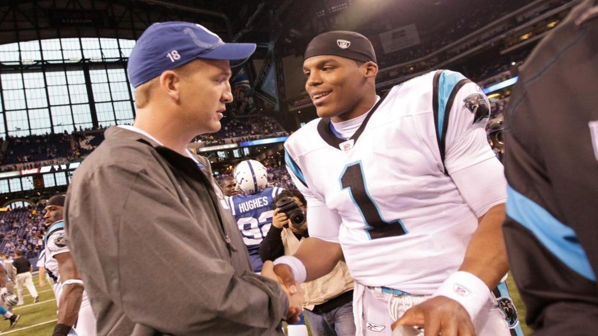 In this Nov. 27, 2011, file photo, injured Indianapolis Colts quarterback Peyton Manning meets with Carolina Panthers quarterback Cam Newton after an NFL football game in Indianapolis.