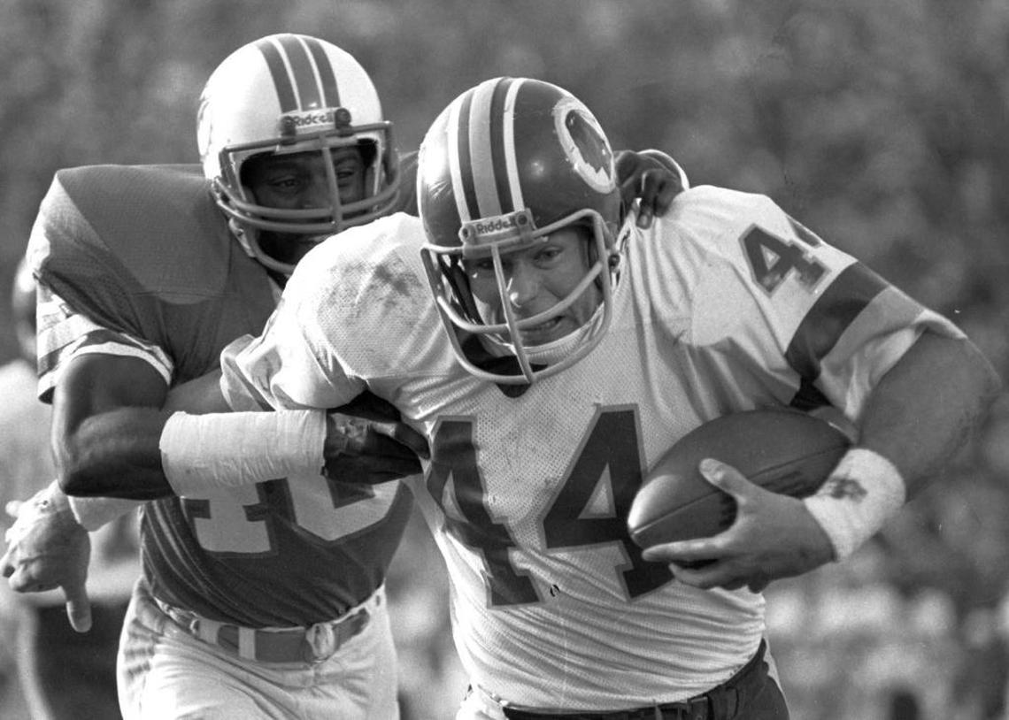Washington running back John Riggins breaks away from Dolphins cornerback Don McNeal on his way to the game-winning touchdown in the fourth quarter of Super Bowl XVII.