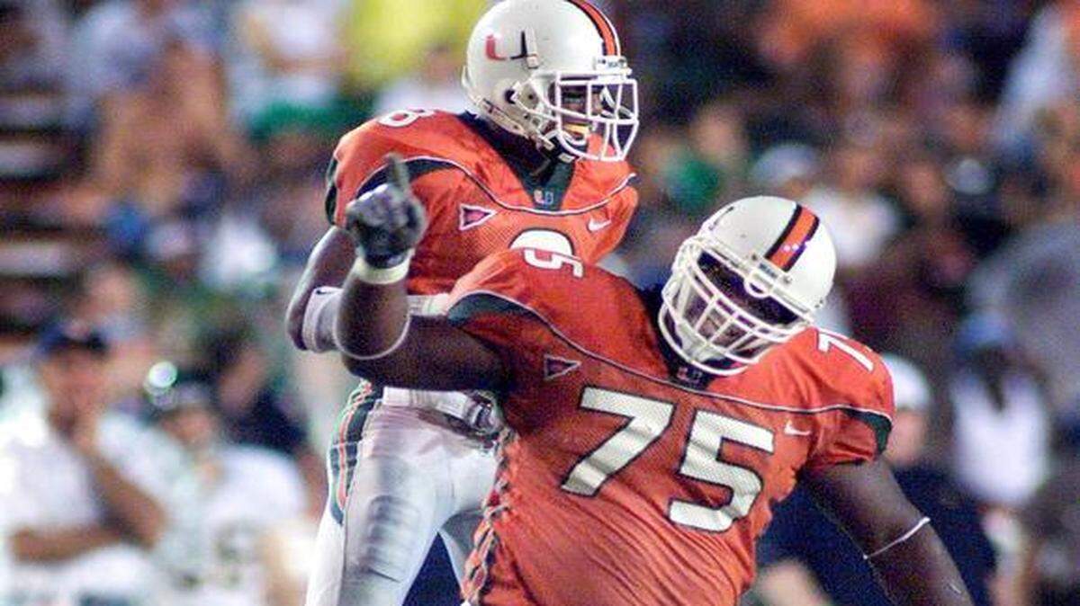 
In the Orange Bowl days: Vince Wilfork (75) celebrates his sack of West Virginia quarterback Derek Jones with teammate Antrel Rolle in 2001.
