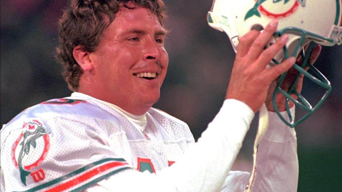 Miami Dolphins quarterback Dan Marino removes his helmet after throwing the winning touchdown against the New York Jets on Nov. 27, 1994, at Giants Stadium in East Rutherford.