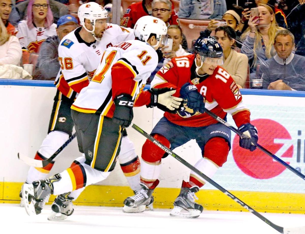 The Florida Panthers Sasha Barkov (16) goes against the Calgary Flames’ Troy Brouwer (36) and Mikael Backlund (11) on Jan. 12.