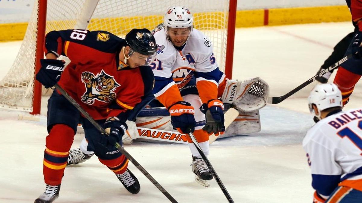 Florida Panthers right wing Reilly Smith (18) attempts a shot at the goal as New York Islanders center Frans Nielsen (51) defends in the first period as the Panthers host the New York Islanders for game 5 of the playoffs at the BB&T Center on Friday, April 22, 2016.