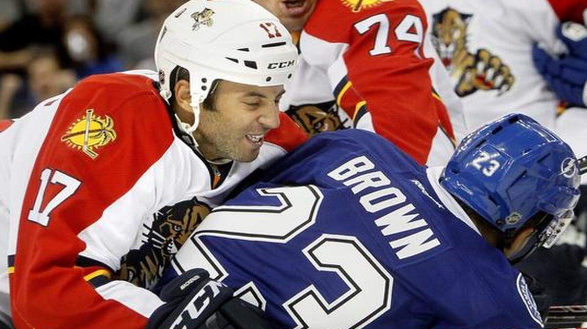 
Tampa Bay Lightning forward J.T. Brown (23) battles against Florida Panthers’ Derek MacKenzie (17) and Shane O'Brien (74) at Amalie Arena on Saturday, Oct. 4, 2014 in Tampa, Fla. 
