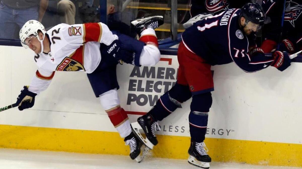 Columbus Blue Jackets forward Nick Foligno, right, checks Florida Panthers forward Frank Vatrano during the third period of an NHL hockey game in Columbus, Ohio, on Thursday, March 22, 2018.