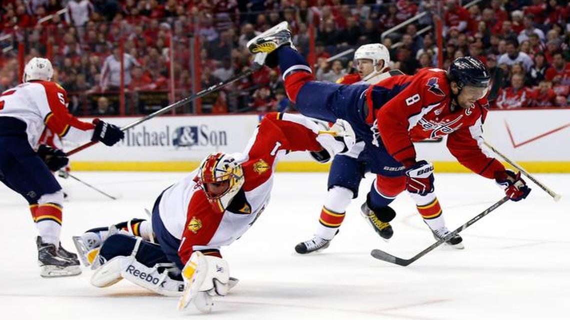 
Washington Capitals left wing Alex Ovechkin (8), from Russia, goes airborne as he collides with Florida Panthers goalie Roberto Luongo (1) in the first period of an NHL hockey game, Sunday, Jan. 4, 2015, in Washington. 
