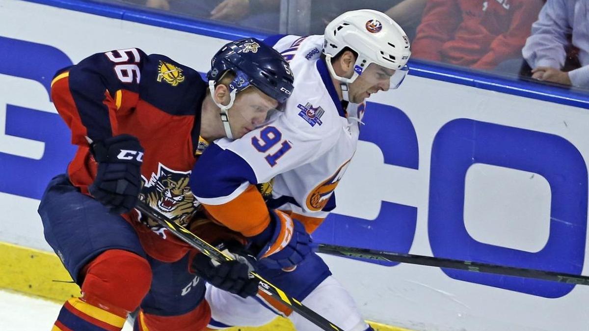 Florida Panthers Michael Matheson pushes New York Islanders John Tavares behind the net in the first period in Game 2 of the first round of the 2016 NHL Stanley Cup Playoffs at the BB&T Center in Sunrise, Florida, Fri., April 15, 2016.