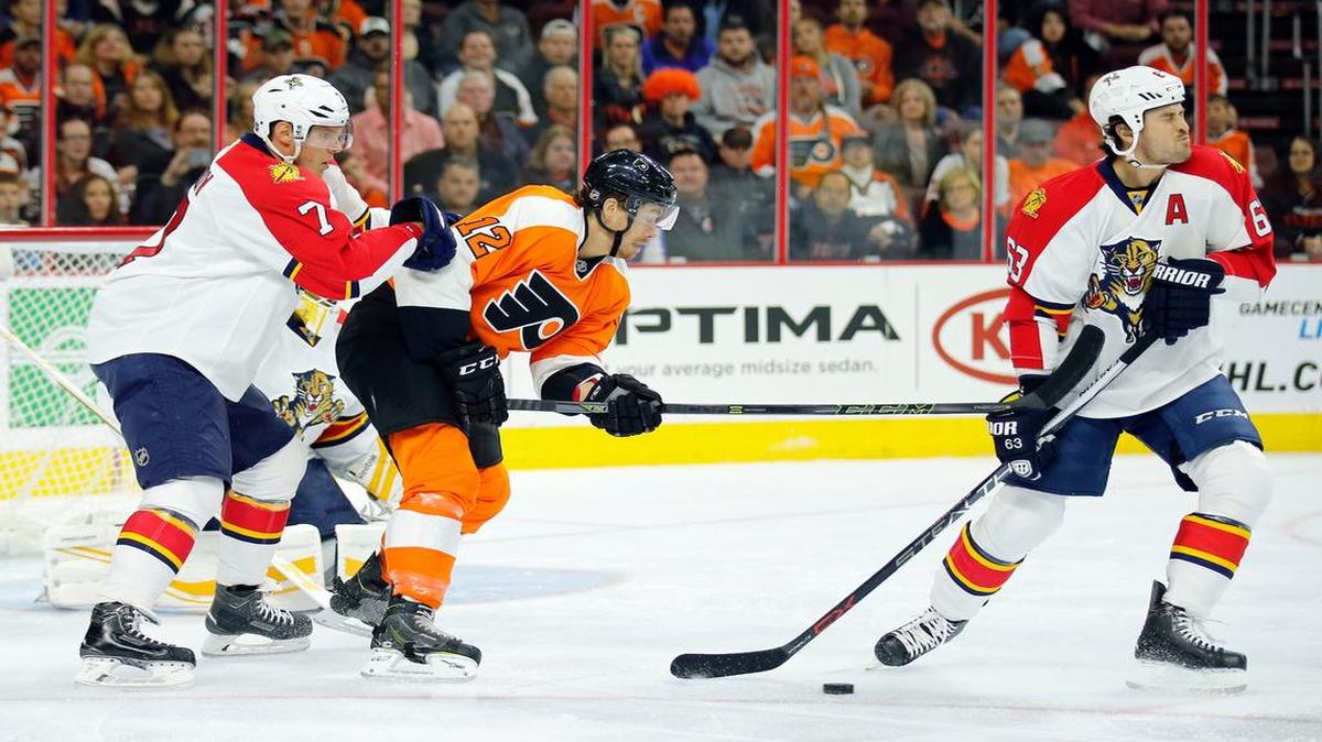 
The Flyers’ Michael Raffl high-sticks the Panthers’ Dave Bolland, right, as Dmitry Kulikov moves in during the first period Monday night. The Flyers defeated the Panthers 1-0. 
