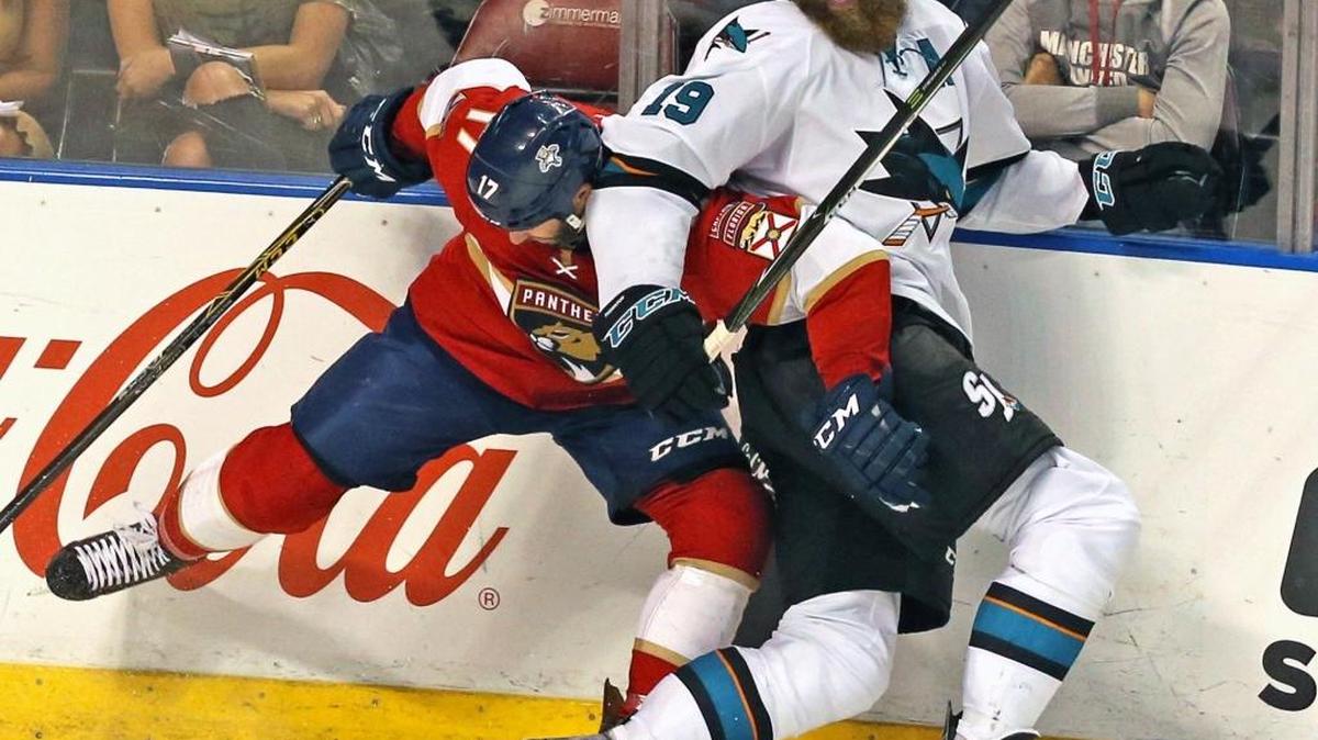 Florida’s Derek MacKenzie and San Jose’s Joe Thornton hit the glass during a game at the BB&T Center on November 10.