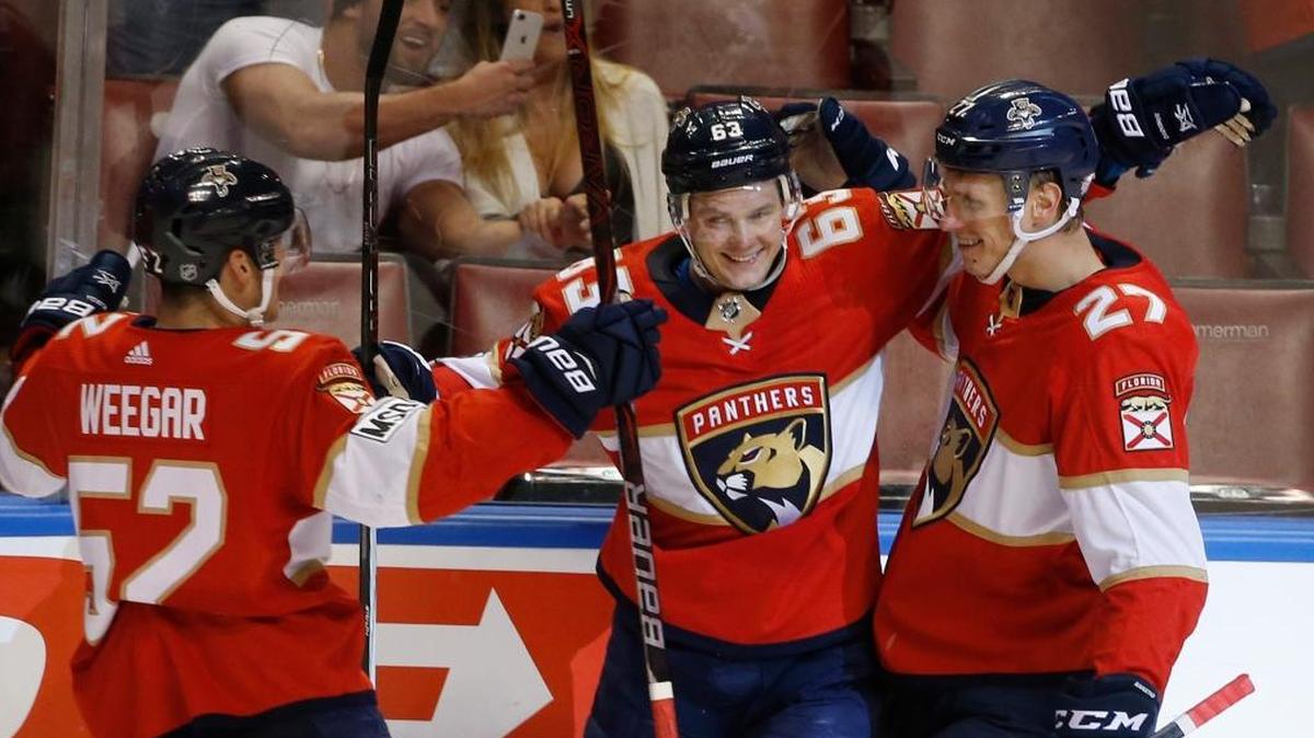 Panthers defenseman MacKenzie Weegar and center Nick Bjugstad, right, celebrate with right wing Evgenii Dadonov (63) after Dadonov scored his second goal against the Philadelphia Flyers on Sunday at BB&T Center in Sunrise.