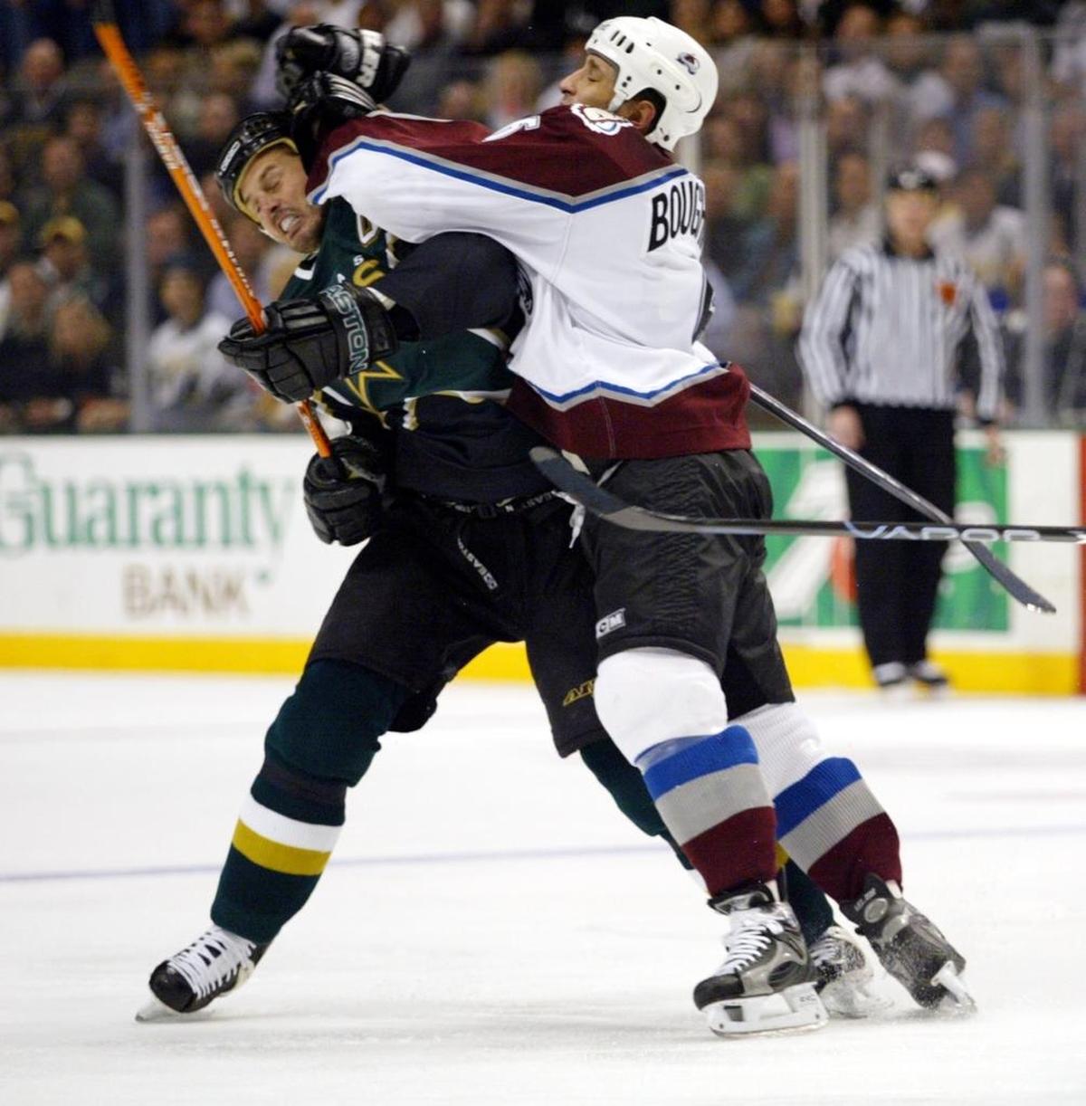 Colorado defenseman Bob Boughner hits Dallas’ Mike Modano on April 12, 2004. Boughner is expected to be announced the 15th coach in Florida Panthers history this week.