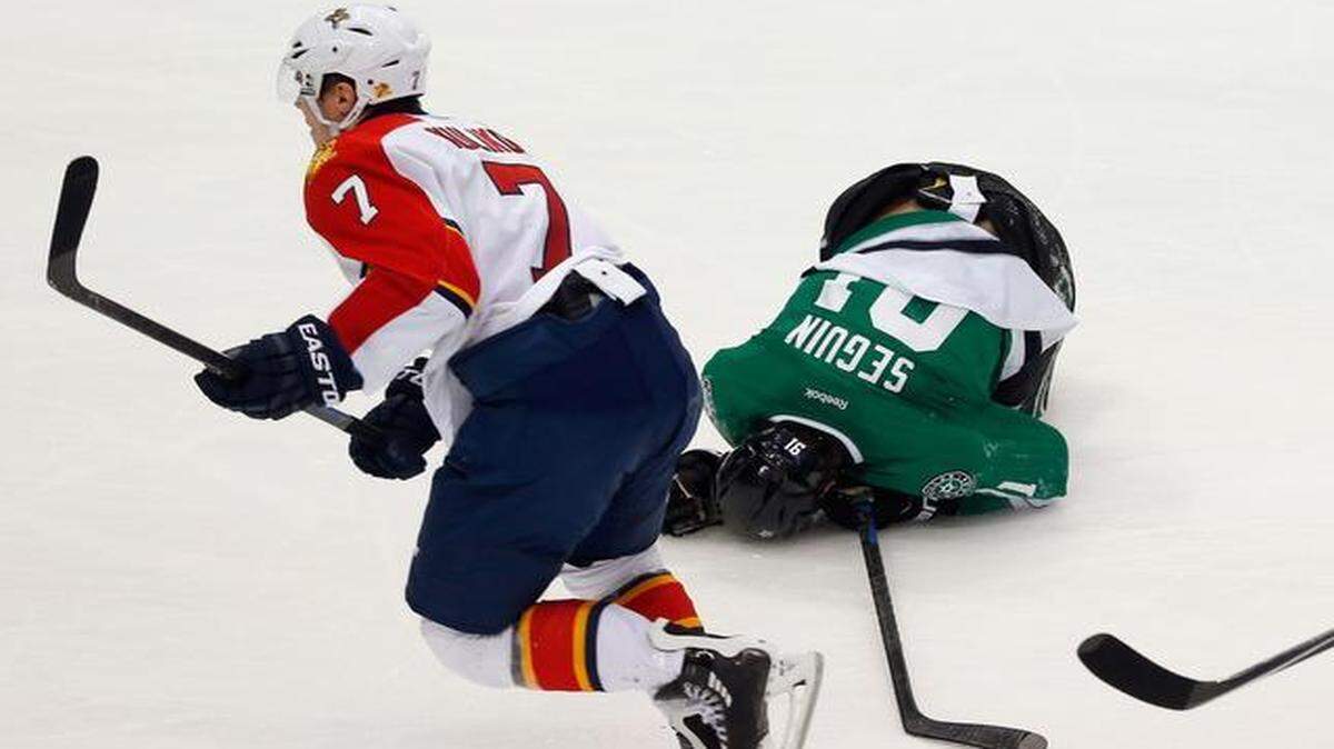 
Tyler Seguin #91 of the Dallas Stars falls to the ice after being hit by Dmitry Kulikov #7 of the Florida Panthers in the third period at American Airlines Center on Feb. 13, 2015 in Dallas, Texas. 
