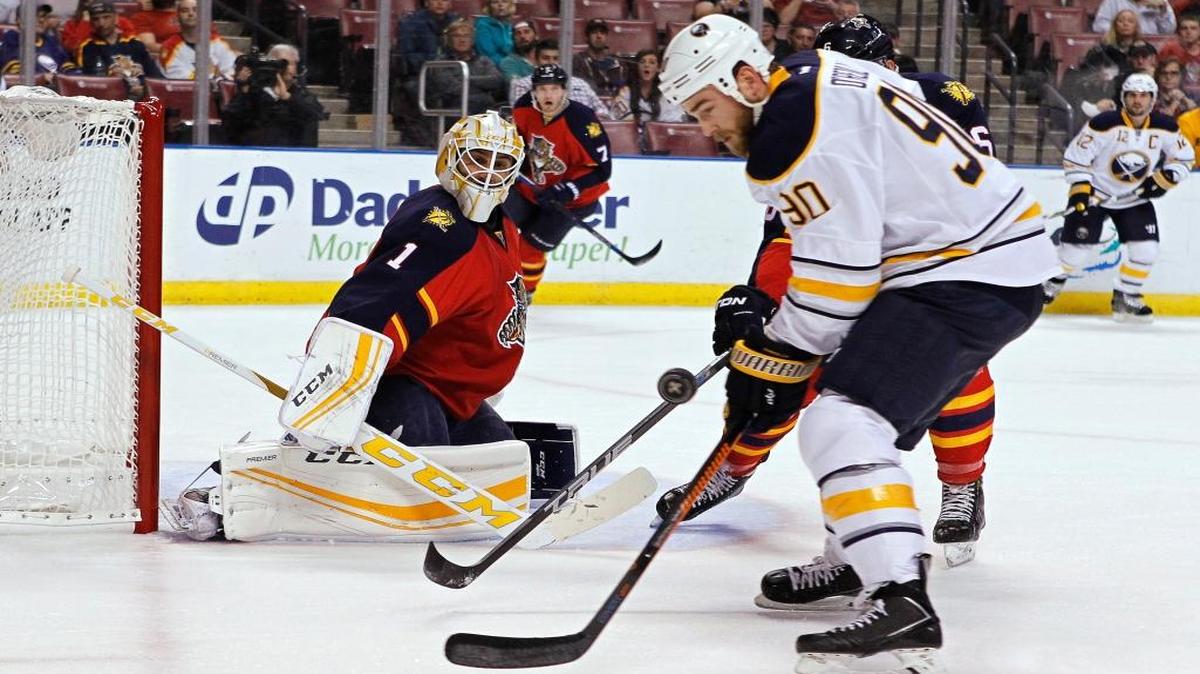 Buffalo Sabres center Ryan O'Reilly (90) tries to control the puck in front of Florida Panthers goalie Roberto Luongo (1) during the first period of an NHL hockey game Thursday, Nov. 12, 2015, in Sunrise, Fla.