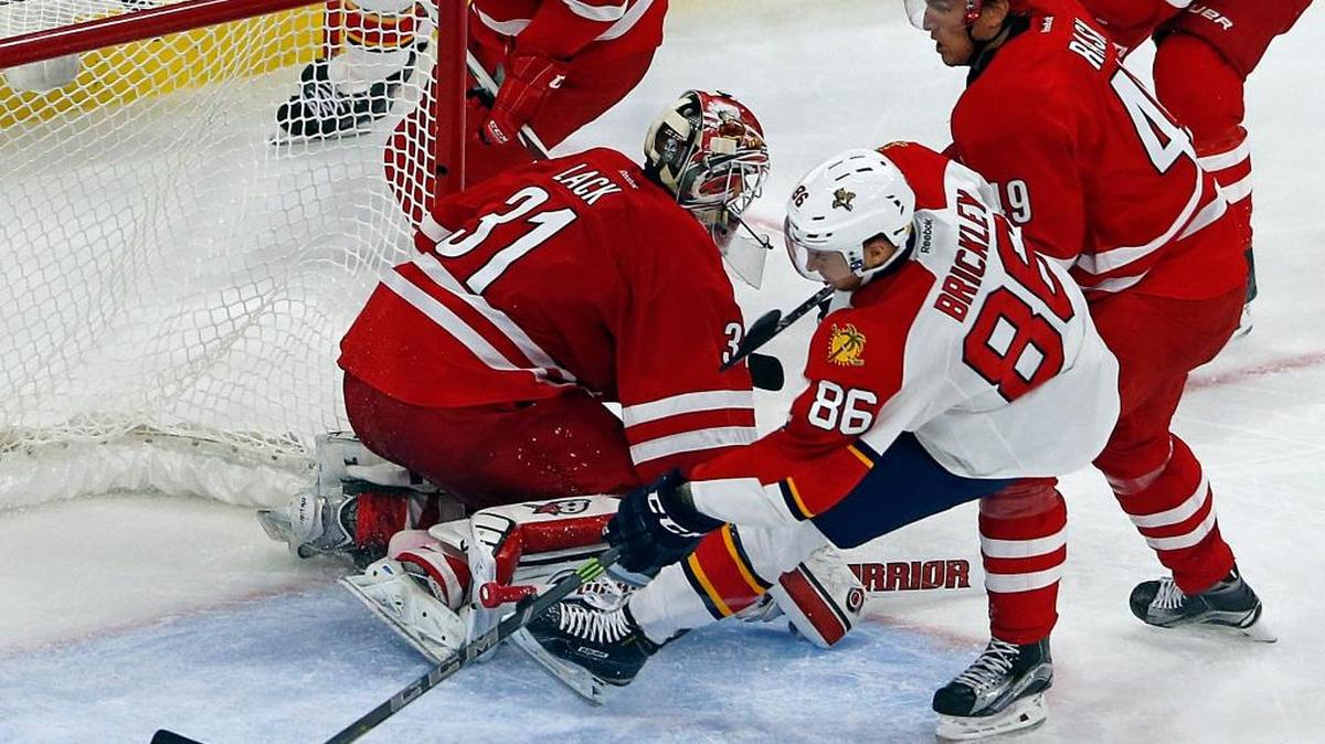 Florida’s Connor Brickley picks up a loose puck in front of Carolina’s Eddie Lack and scores his first NHL goal on Oct. 13, 2015, against the Huricanes.