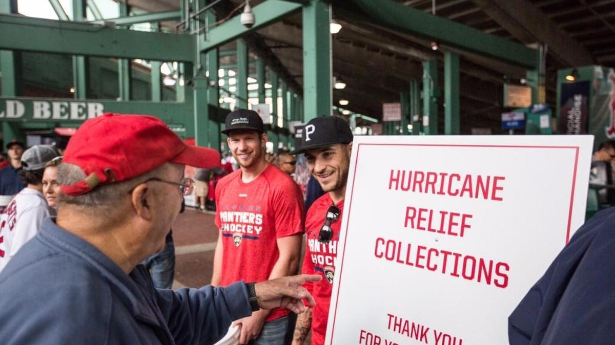 Florida Panthers goalie James Reimer and forward Colton Sceviour collect funds for hurricane relief outside Fenway Park in Boston on Sunday.