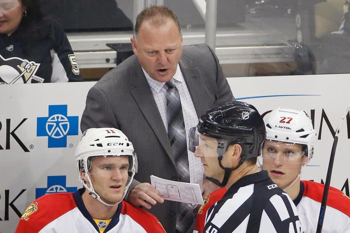 Florida coach Gerard Gallant has a talk with referee Steve Kozari during a game against the Pittsburgh Penguins on Dec. 20, 2014 as Jonathan Huberdeau and Nick Bjugstad listen in.