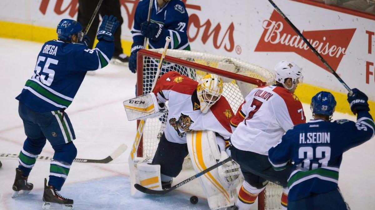 The Canucks’ Daniel Sedin (22) celebrates his goal past Panthers goalie Roberto Luongo late Monday night.