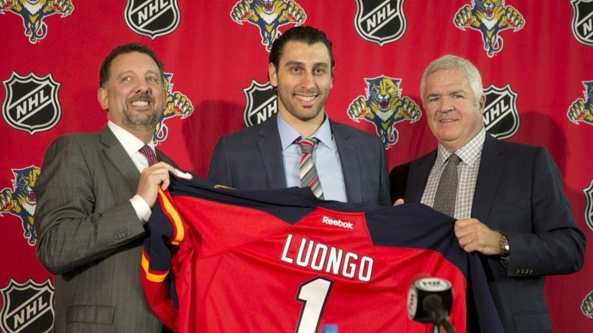 Florida Panthers goalie Roberto Luongo, center, is joined by former team CEO and president Rory Babich, left, and general manager Dale Tallon on March 5, 2014, days after Luongo came back to Florida in a deal with Vancouver.
