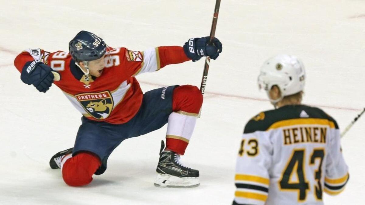 Florida Panthers Jared McCann (90) slides across the ice after scoring the winning goal in the third period as they defeat the Boston Bruins at the BB&T Center in Sunrise, Florida, on April 5, 2018.