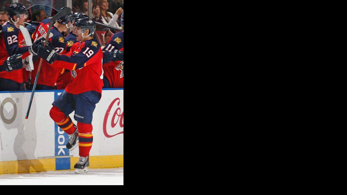 
Scottie Upshall (19) of the Florida Panthers celebrates after scoring his third goal of the game for a hat trick against the Calgary Flames at the BB&T Center in Sunrise on Nov. 8, 2014. The goal was later awarded to a different player after video review.
