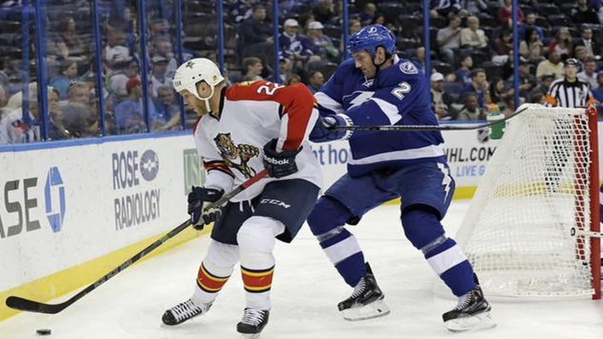 
In the corner: Panthers right wing Shawn Thornton , left, works the puck in front of Lightning defenseman Eric Brewer during Saturday’s game. 
