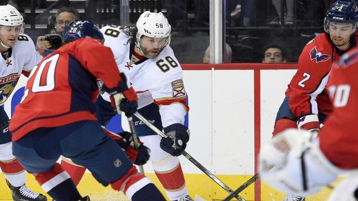 Florida Panthers right wing Jaromir Jagr (68), of the Czech Republic, skates with the puck against Washington Capitals defenseman Matt Niskanen (2) and Lars Eller (20) during the first period of an NHL hockey game, Saturday, Nov. 5, 2016, in Washington.