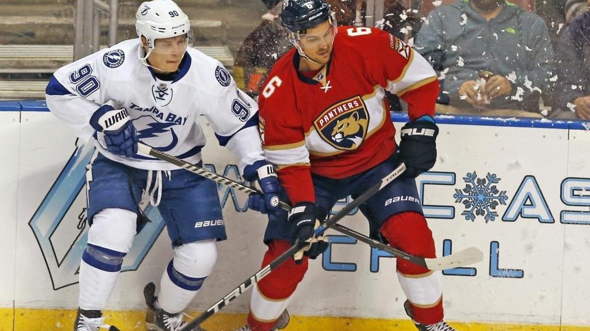 Alex Petrovic fights Tampa Bay’s Vladislav Namestnikov for the puck at BB&T Center last Thursday night.