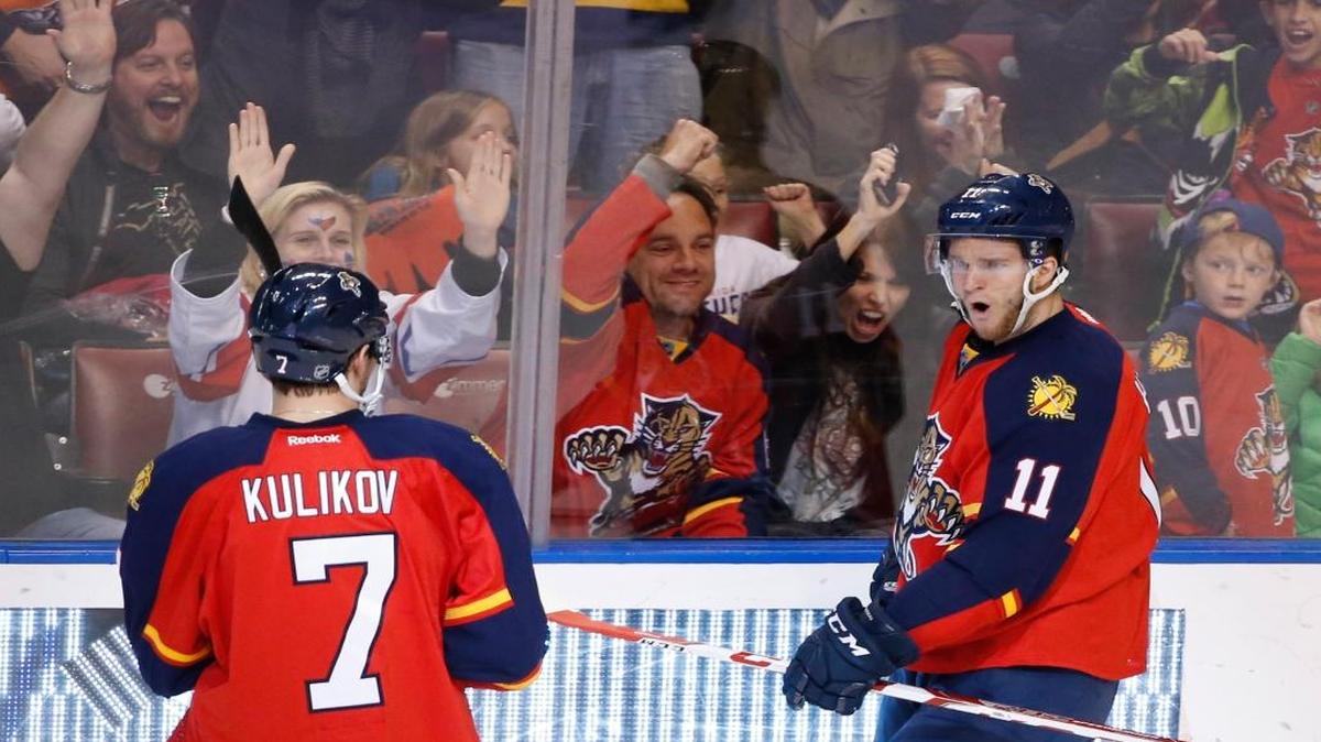 Florida Panthers left wing Jonathan Huberdeau (11) celebrates with defenseman Dmitry Kulikov (7) after scoring a goal during the second period of an NHL hockey game against the Tampa Bay Lightning, Saturday, Jan. 23, 2016 in Sunrise, Fla.