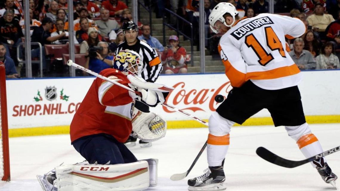 Florida Panthers goalie Roberto Luongo, left, makes a save against Philadelphia Flyers center Sean Couturier (14) during the first period, Tues., Nov. 22, 2016, in Sunrise, Fla.