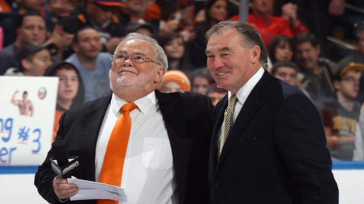 
FILE: (L-R) Jiggs McDonald and Ed Westfall watch a banner raising in honor of Ed Westfall prior to the game between the New York Islanders and the Boston Bruins at the Nassau Veterans Memorial Coliseum on Nov. 19, 2011, in Uniondale, New York.
