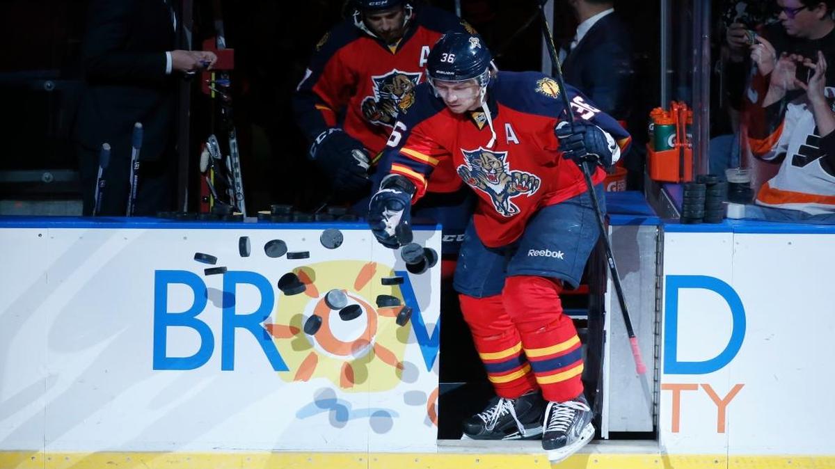 Florida Panthers left wing Jussi Jokinen (36) knocks over practice pucks as he heads on the ice during warmups before a game against the Philadelphia Flyers, Saturday, March 12, 2016 in Sunrise, Fla.